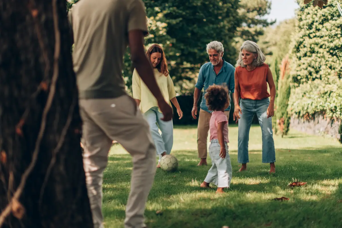 Image shows a diverse family playing in the park